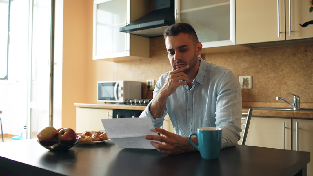 Person comparing car lease quotes on a laptop at a kitchen table